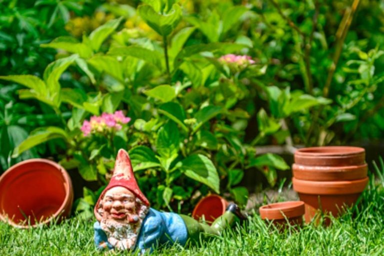 Solar Light Gnome Laying on Clock Statue